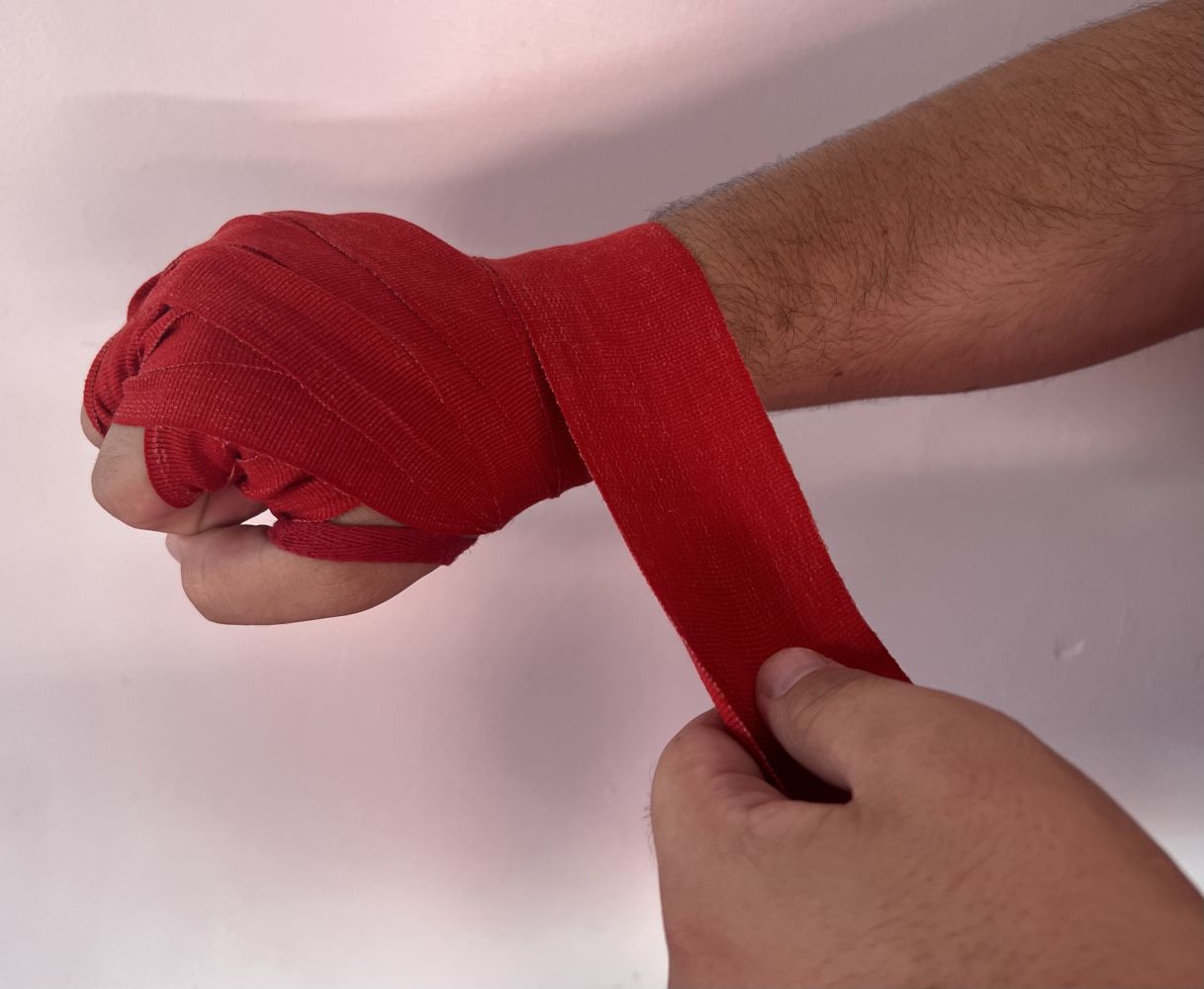 Muay Thai beginner wrapping his hands